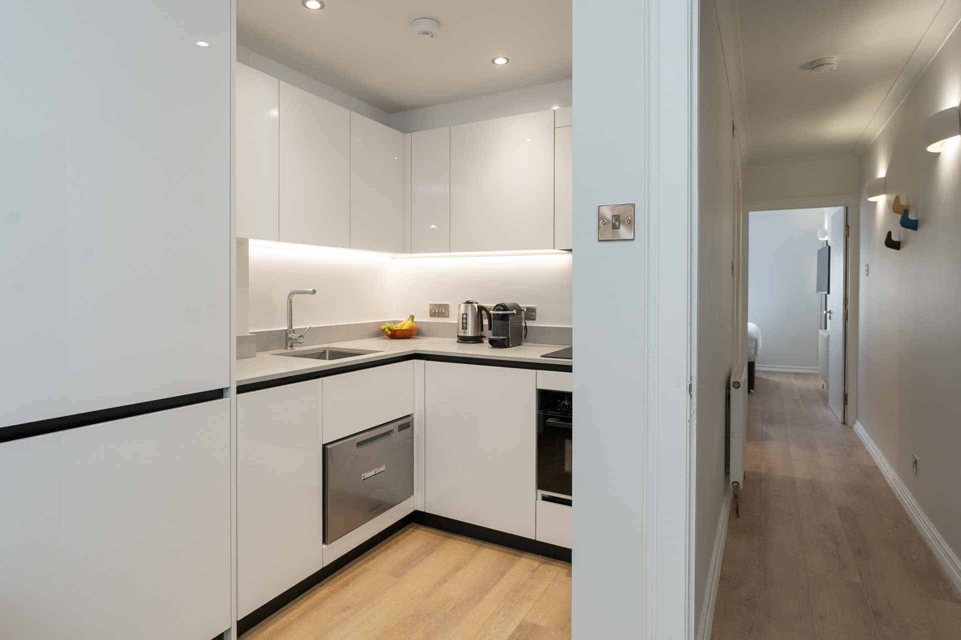 premier suites plus edinburgh fountain court kitchen with corridor leading to bedroom